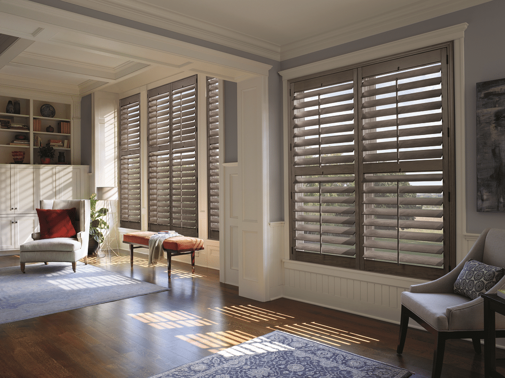 Stained wood plantation shutters in windows in a modern home.
